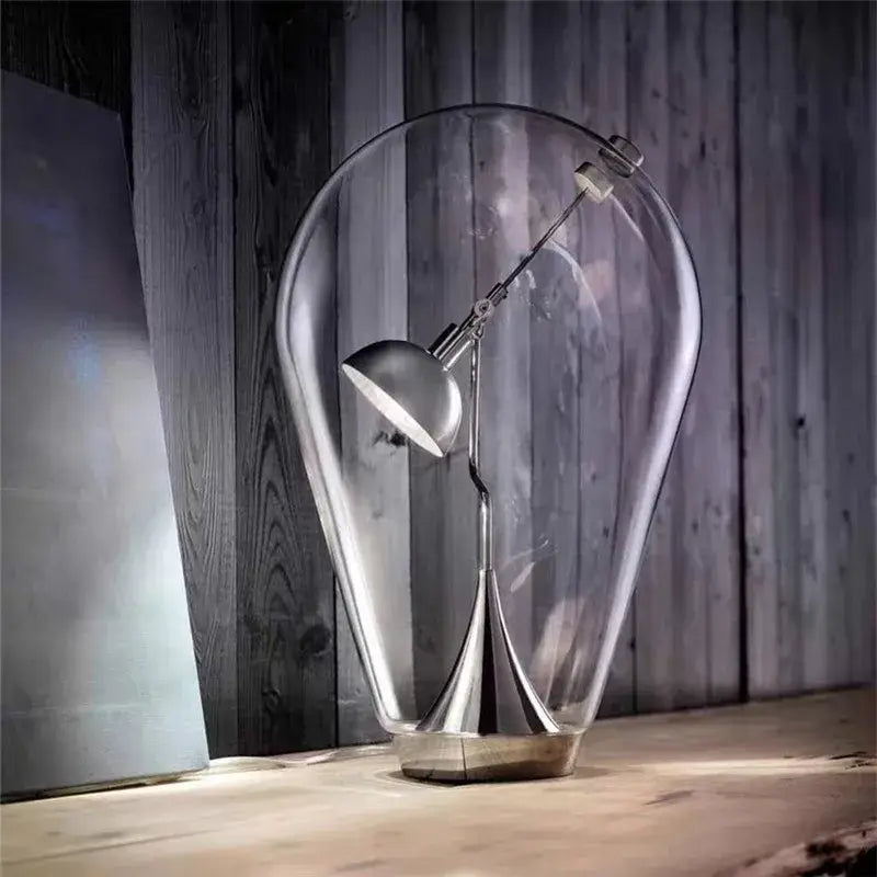 Modern chrome lodes blow glass table lamp with metallic silver finish and adjustable arm in a transparent dome for living room decorbites lodes blow