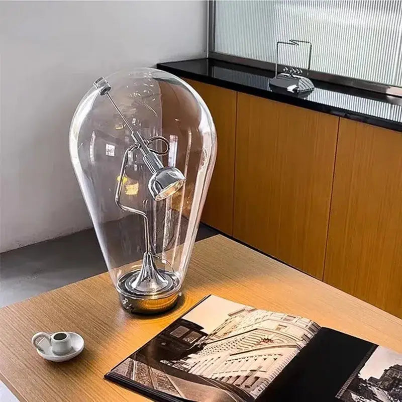 Modern chrome and transparent blow glass table lamp with chrome-finished spotlight and base by decorbites lodes blow