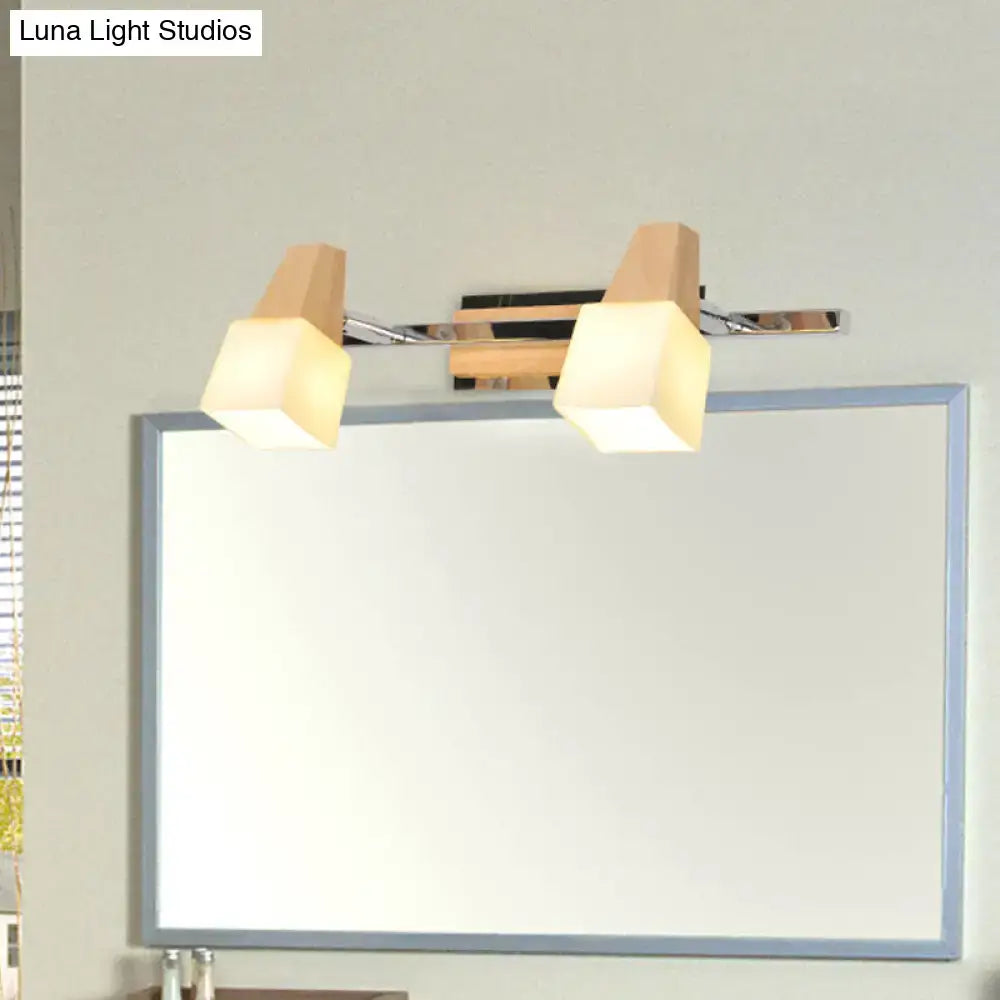 Modern chrome and wood cube vanity light fixture with dual warm frosted glass shades and beige cube vanity accents