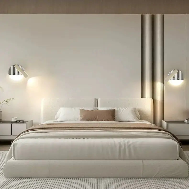 Modern platform bed with upholstered beige headboard paired with chrome and wood full spectrum eye protection wall lamp