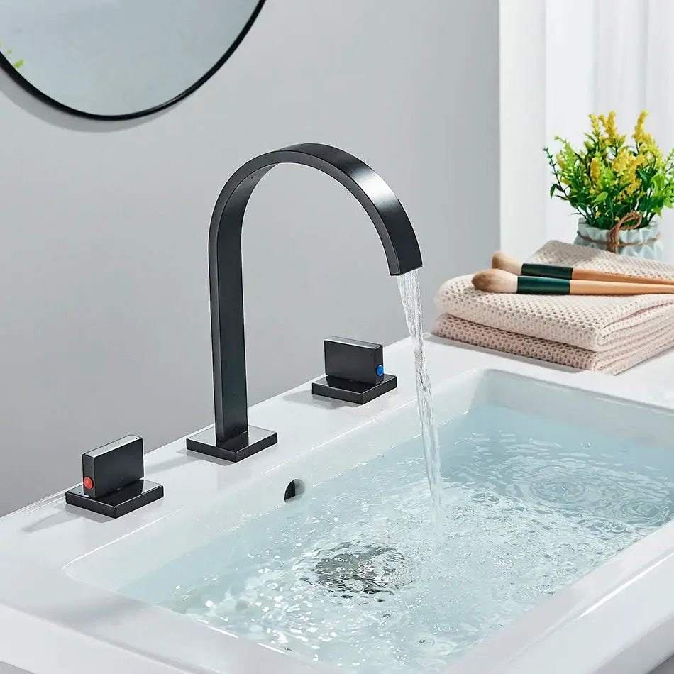 Black matte basin faucet with sleek curved spout and dual handle marked red and blue decorbites dual handle design