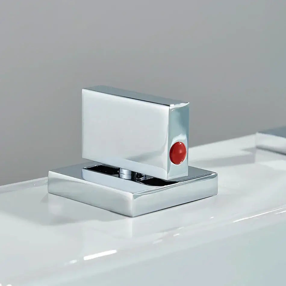 Modern chrome arched dual handle basin faucet featuring a chrome-finished rectangular glass door handle with red button