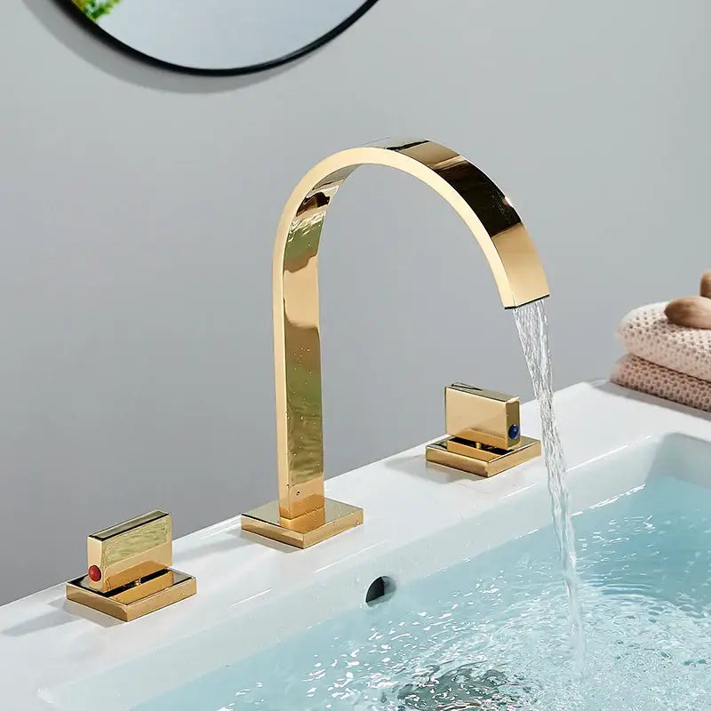 Modern chrome arched dual handle basin faucet with gold-toned waterfall spout and polished finish decorbites dual handle design