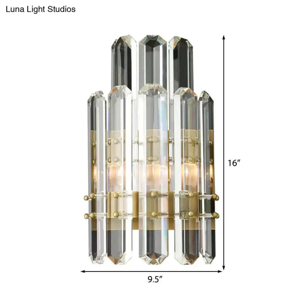 Modern chrome and black crystal wall sconce with brass accents featuring direct wired electric power source design