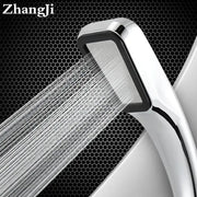 A sleek modern chrome and black rainfall shower head with a rectangular face handheld for bathroom use