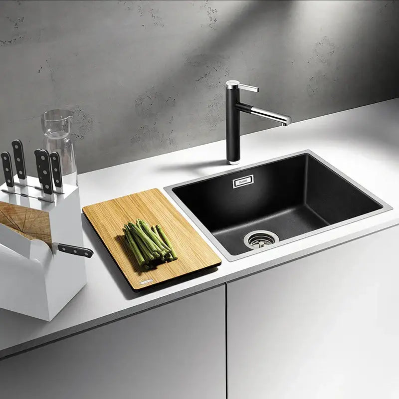 Black stainless steel undermount sink with integrated drain paired with modern chrome brass bathroom faucet vessel swivel spout tap
