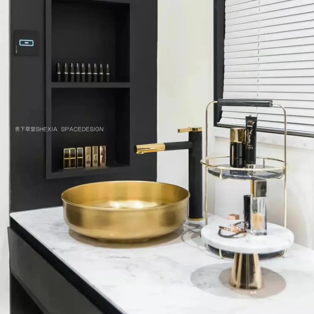 Gold bowl sink with polished metallic finish paired with modern chrome brass bathroom faucet vessel swivel spout tap