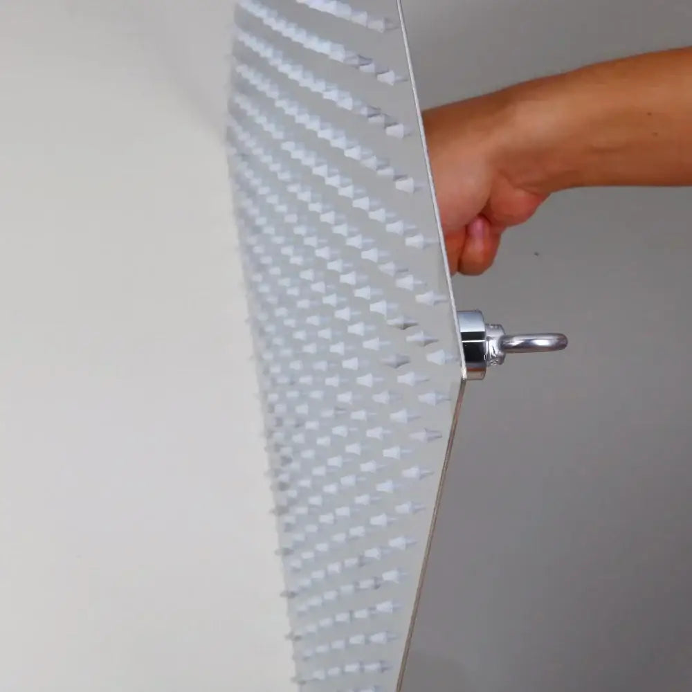 Modern chrome brass square rain shower head in white with textured triangular nozzles and polished chrome hook attachment