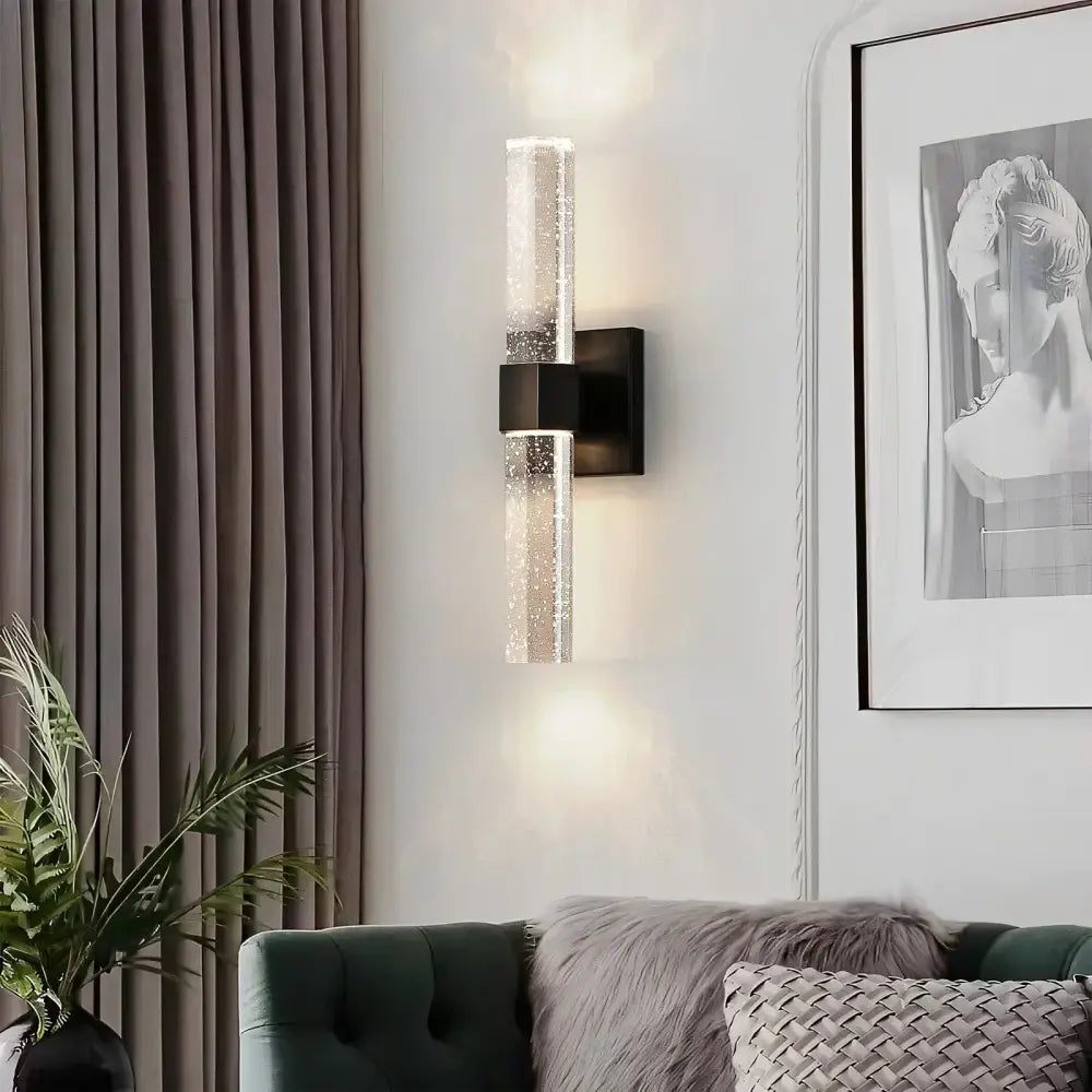 Modern wall lamp with clear textured glass cylinder and black metal base for decorbites bubble crystal led lighting