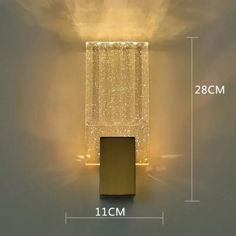 A modern chrome decorbites bubble crystal led wall lamp with a sparkling glass body and sleek metallic base for bathroom