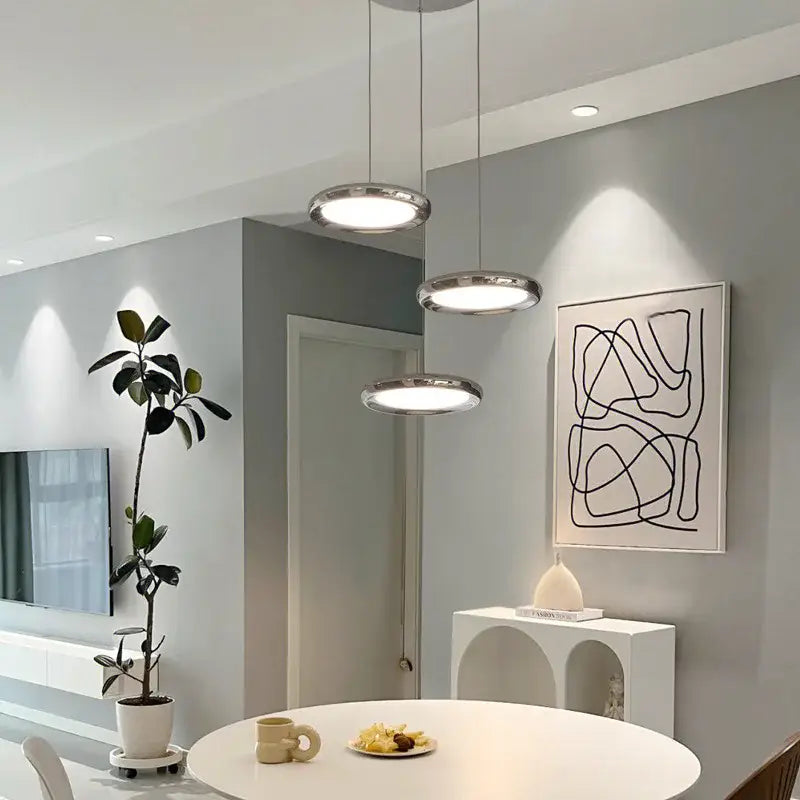 Three modern chrome circular dining pendant led lights with sleek frames and soft white illumination for kitchen decorbites circular dining use