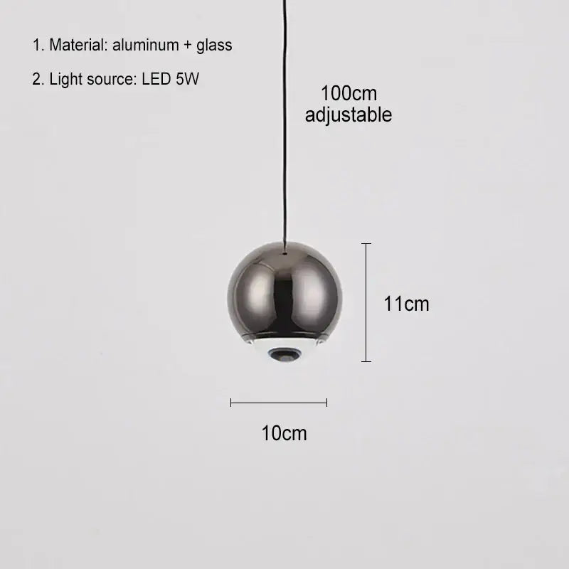 A sleek modern chrome ball pendant light with reflective finish and glass construction for dining room lighting