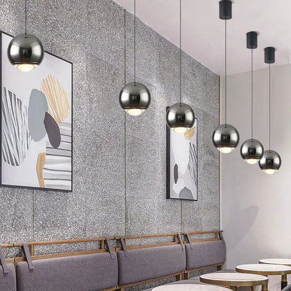 Modern chrome and copper ball pendant light with spherical chrome finish designed as a pendant light modern chandelier