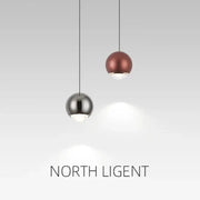 Two spherical pendant lights in polished chrome and matte copper tones for modern dining room lighting