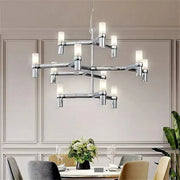 Modern chrome crown major chandelier with cylindrical frosted glass shades in a multi tiered kitchen light design decorbites crown major