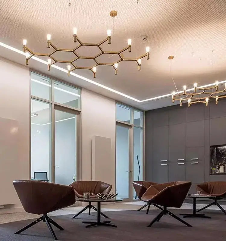 Gold-toned hexagonal decorbites crown major chandelier with exposed bulbs for modern multi tiered kitchen lighting