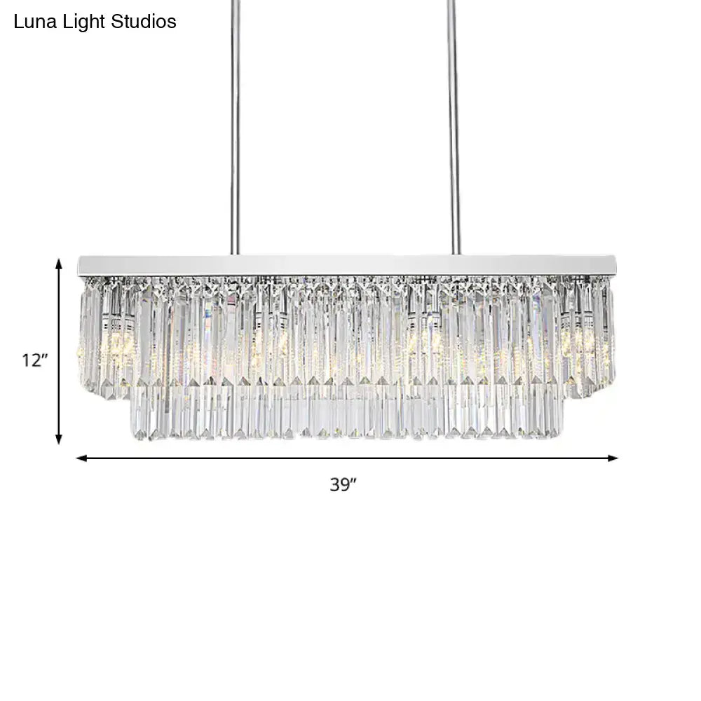 A modern chrome island light with a rectangular frame and cascading clear crystal prisms with chain cord for e12 e14 bulbs