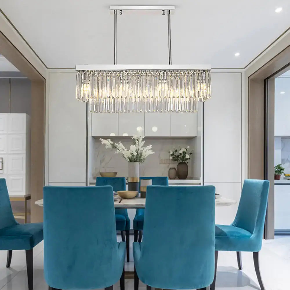 A modern chrome island light with cascading clear crystal prisms and chain cord for e12 e14 bulbs in dining room use