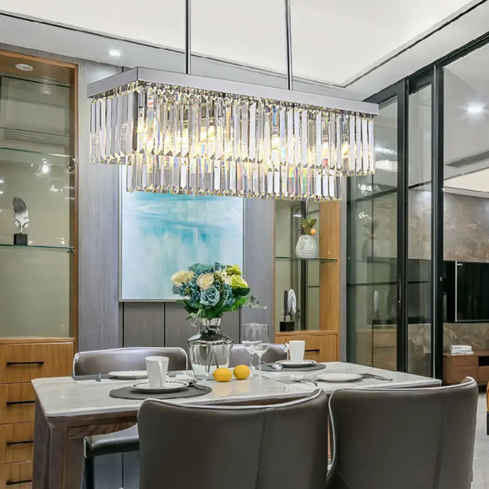 A modern chrome island light with a rectangular frame and clear crystal prisms featuring e12 e14 chain cord pendants