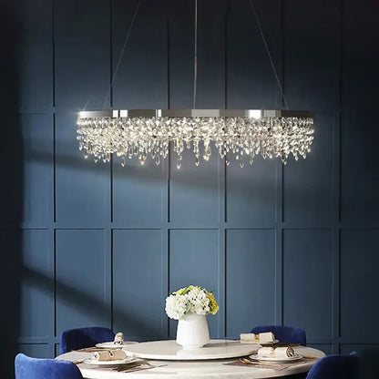 A modern chrome decorbites crystal circle led chandelier with sleek metallic frame and cascading crystal droplets for living room decor