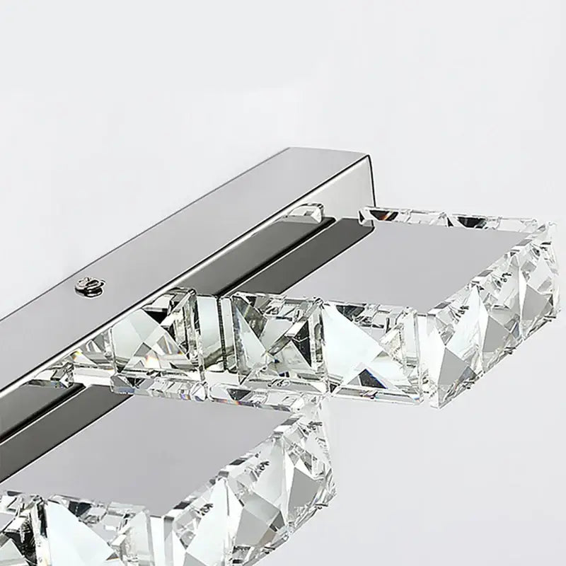 A modern chrome crystal led mirror light bathroom sconce with polished chrome base and faceted glass crystals decorbites crystal led