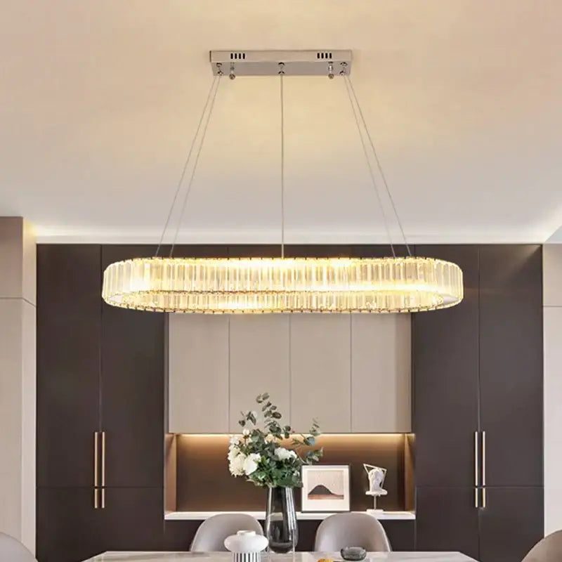 Modern chrome crystal oval led chandelier with cascading crystal rods emitting warm light for luxury living room decorbites crystal oval