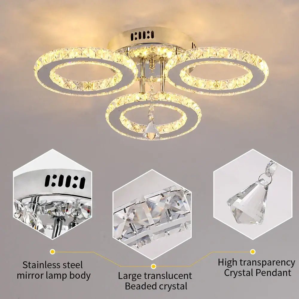 Modern chrome crystal raindrop chandelier ceiling light with gold-toned interlocking rings and dangling high transparency crystal pendant