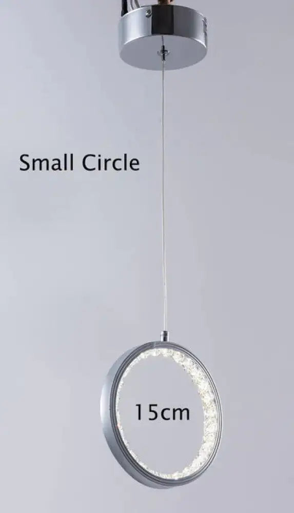 A modern chrome pendant light with crystal rings led inner ring for indoor use in bedroom and dining room