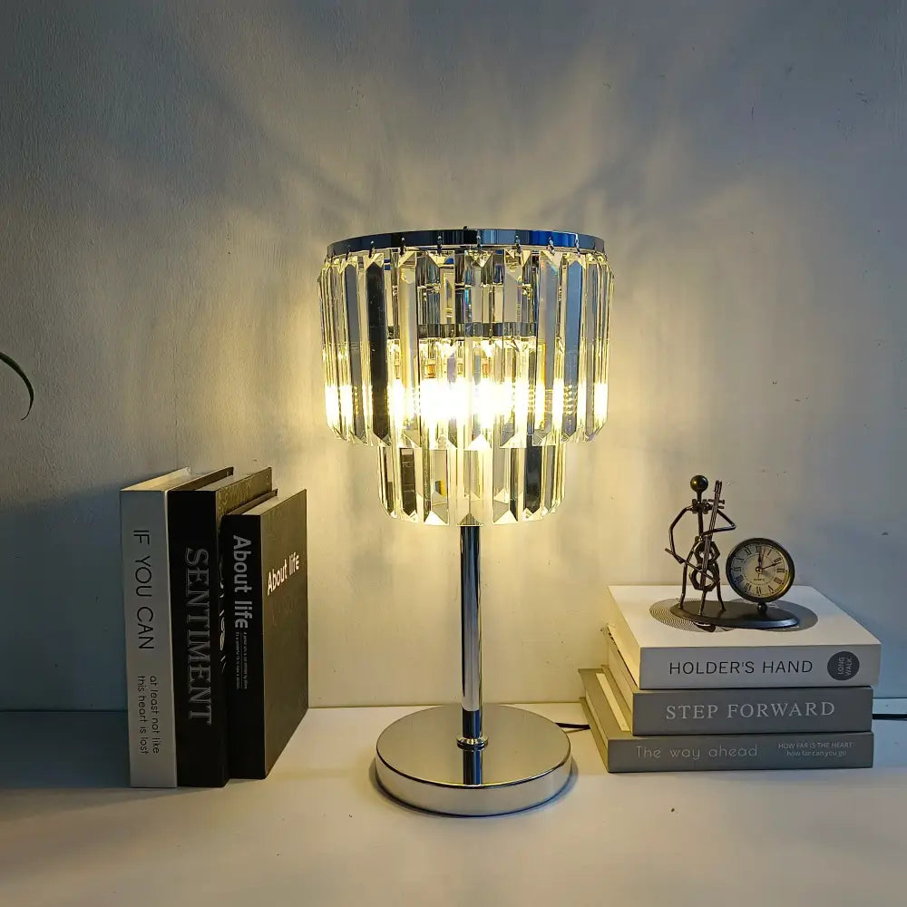 A sleek chrome crystal table lamp with cascading shade emits warm light for modern living room decor table lamps