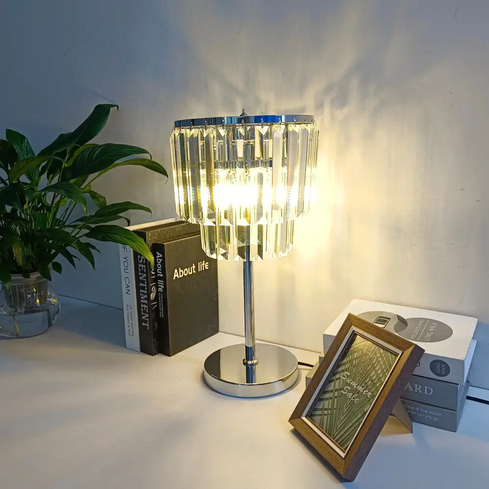 Modern chrome crystal table lamp with cascading clear prisms on a chrome base for elegant living room decorbites decor