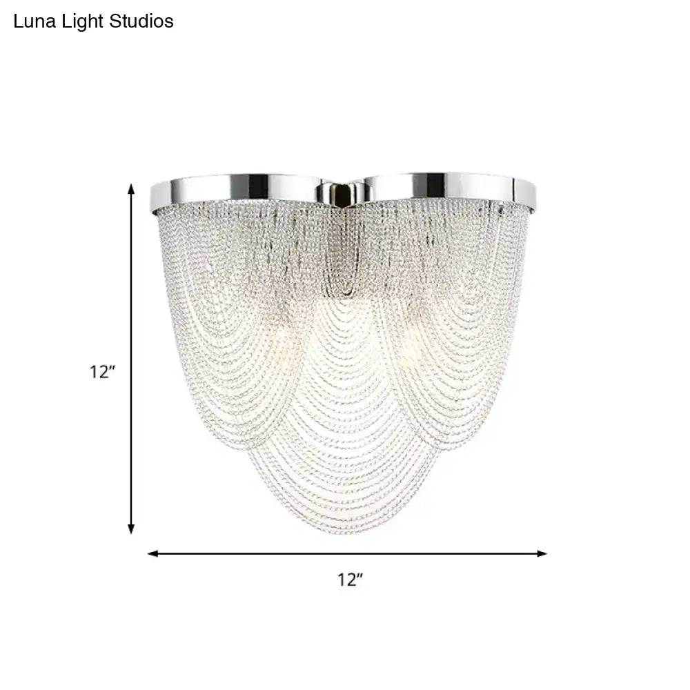Modern chrome crystal tassel wall light featuring cascading clear crystal beads for bedroom lighting