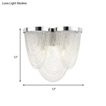 Modern chrome crystal tassel wall light featuring cascading clear crystal beads for bedroom lighting