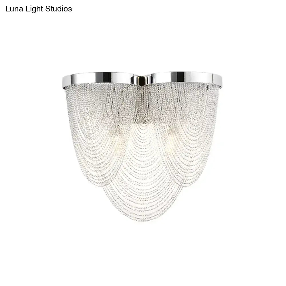 Modern chrome crystal tassel wall light with polished frame and cascading clear beads for bedroom lighting