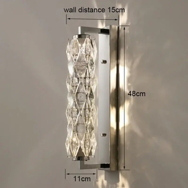 Modern chrome crystal wall lamp with faceted glass elements in a sleek vertical design for luxury bedroom lighting decorbites crystal wall lamp