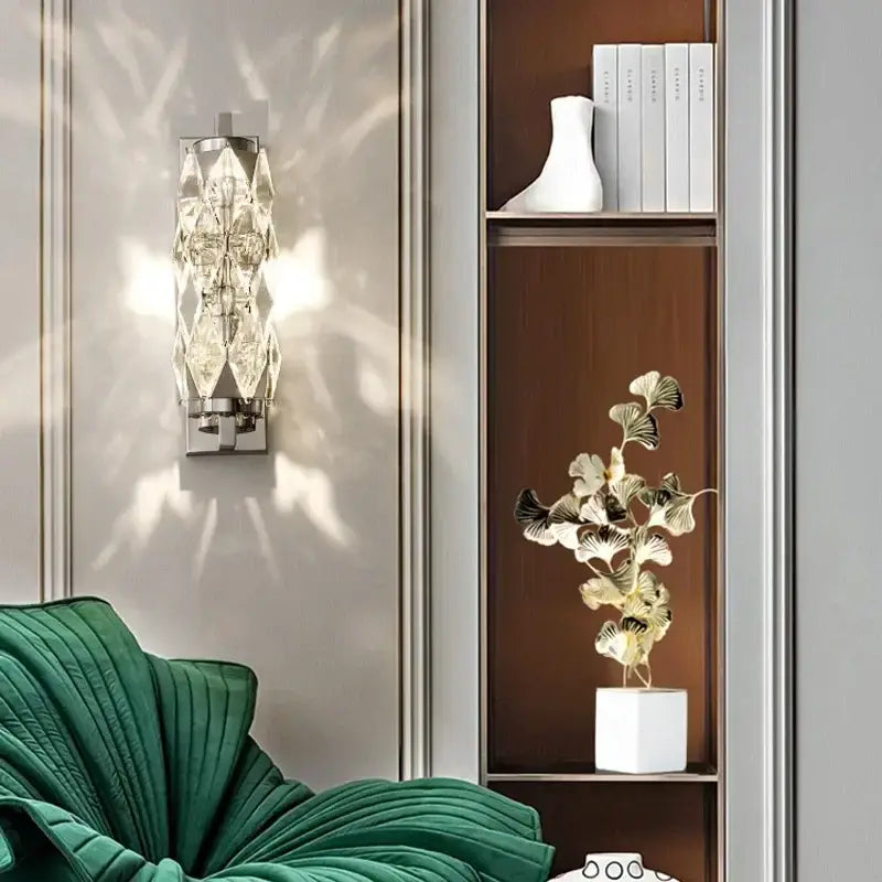 Modern chrome crystal wall lamp with faceted geometric design and polished chrome base for bedroom luxury lighting decorbites crystal wall