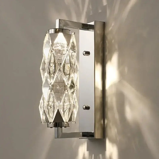 Modern chrome crystal wall lamp features a sleek frame with cascading clear crystal facets for luxury bedroom lighting decorbites wall lamp
