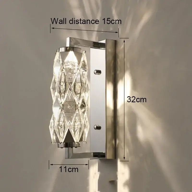 Modern chrome crystal wall lamp with sleek chrome bracket and faceted clear glass diffuser for luxury bedroom lighting