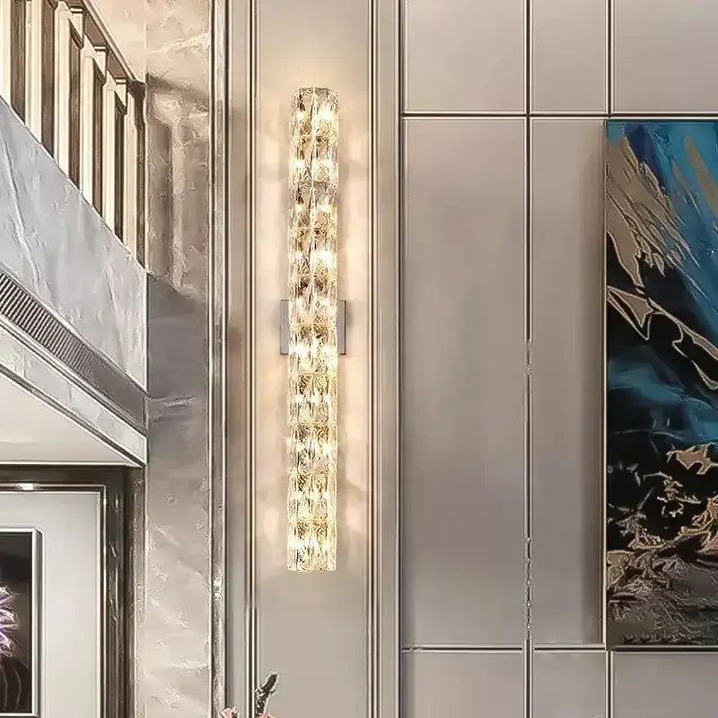 Modern chrome crystal wall light with stacked crystal segments refracting warm golden light for luxury living room decorbites crystal wall