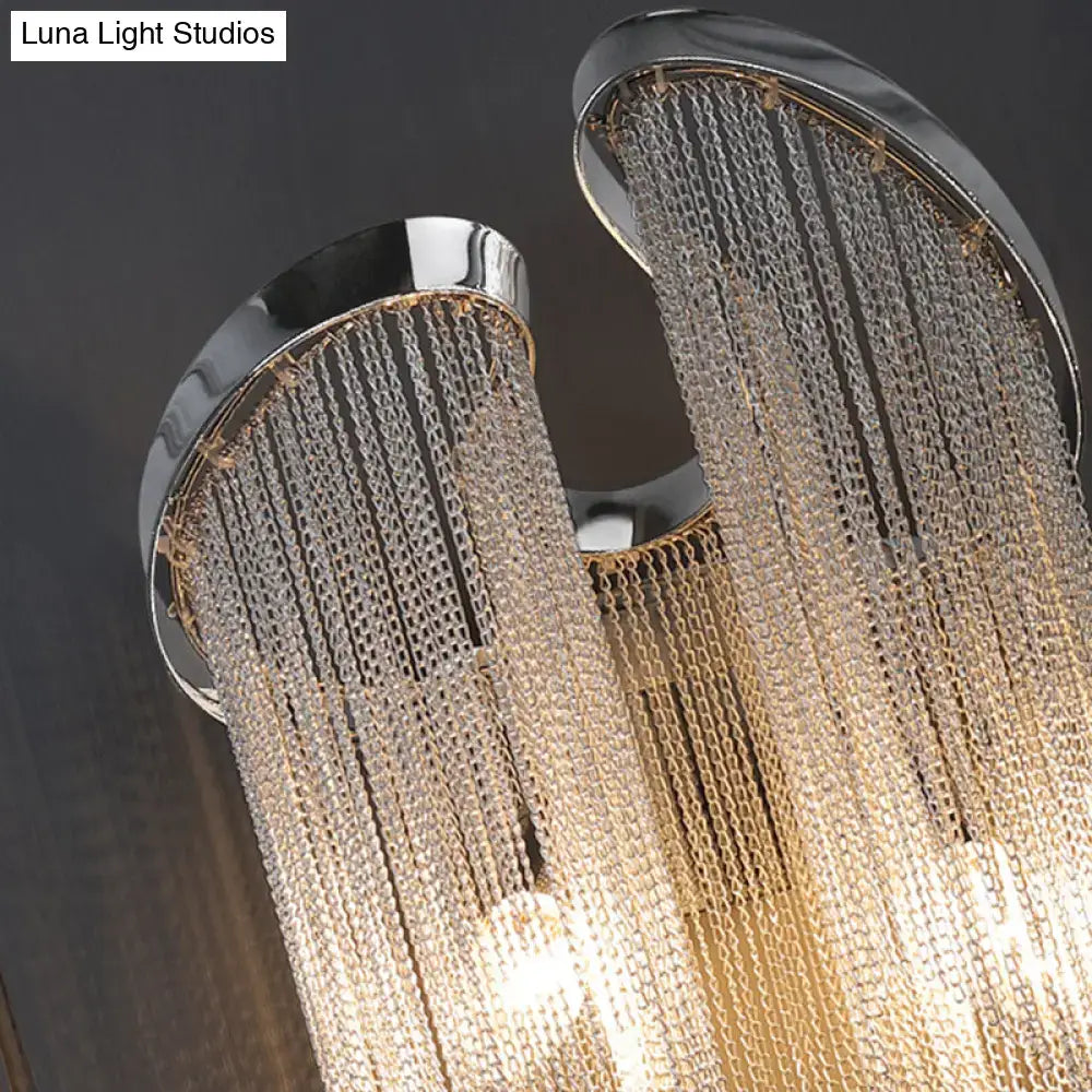 Modern chrome crystal wall sconce featuring cascading chains of clear crystal beads for bedside bedroom lighting