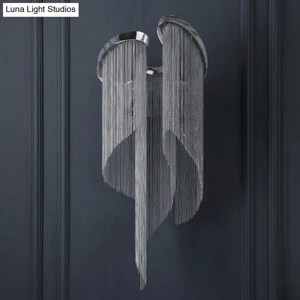 Modern chrome crystal wall sconce with silver chain chandelier featuring wing-like design and metallic finish for bedroom use