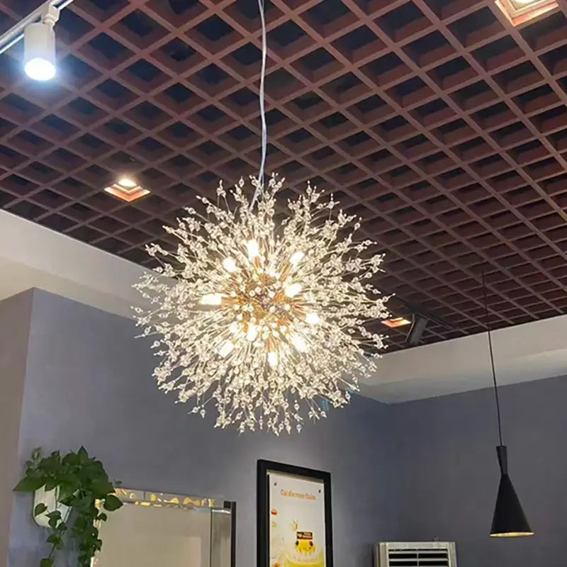 A modern pendant light with polished chrome finish and clear acrylic beads in a spherical dandelion design
