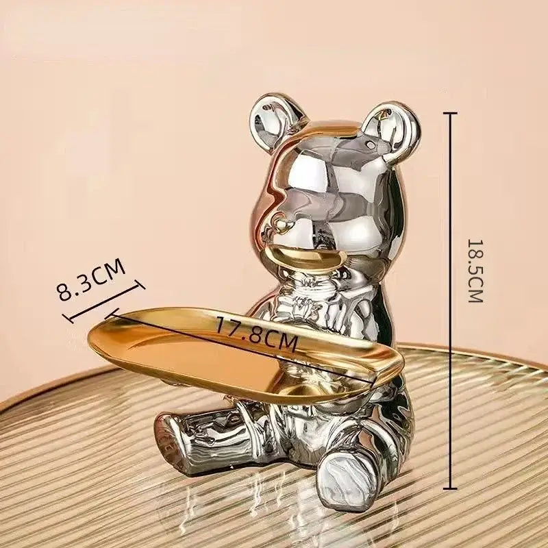 Shiny metallic chrome decorbites bear doll storage tray with gold-colored tray held in paws for living room key holder