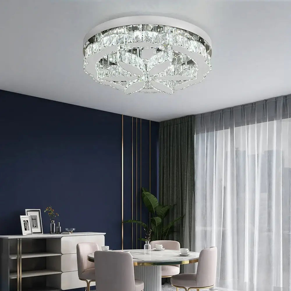 A modern chrome decorbites crystal ceiling chandelier with clear crystal accents and a white metallic frame for living rooms
