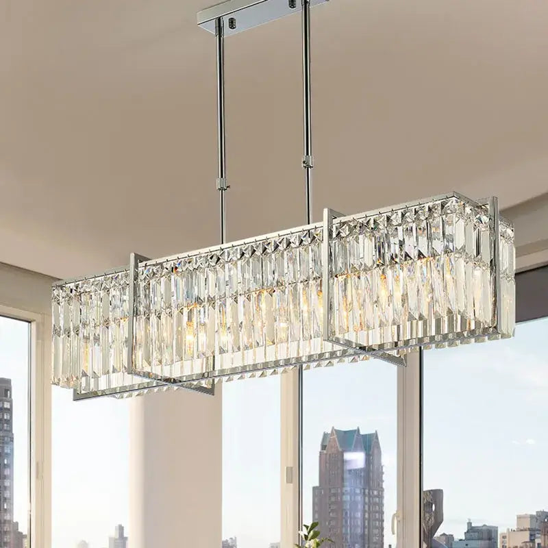 A modern chrome decorbites crystal chandelier with rectangular frame and clear prisms for dining room lighting