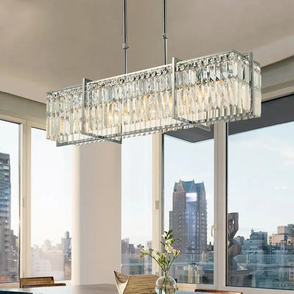 A modern chrome decorbites crystal chandelier with clear crystal prisms for dining room lighting