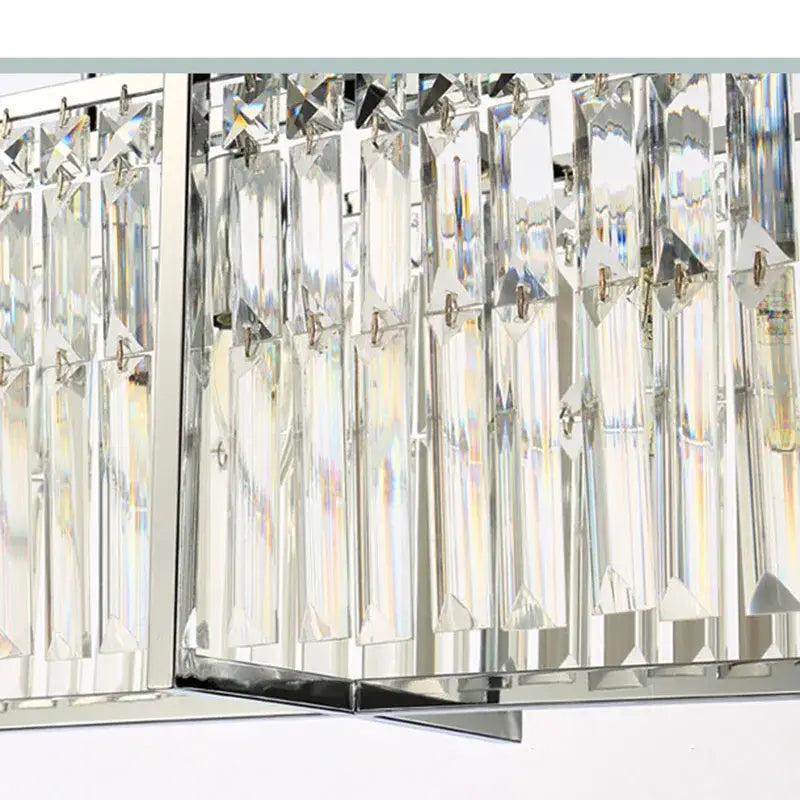 A modern chrome decorbites crystal chandelier with clear faceted glass prisms for dining room lighting