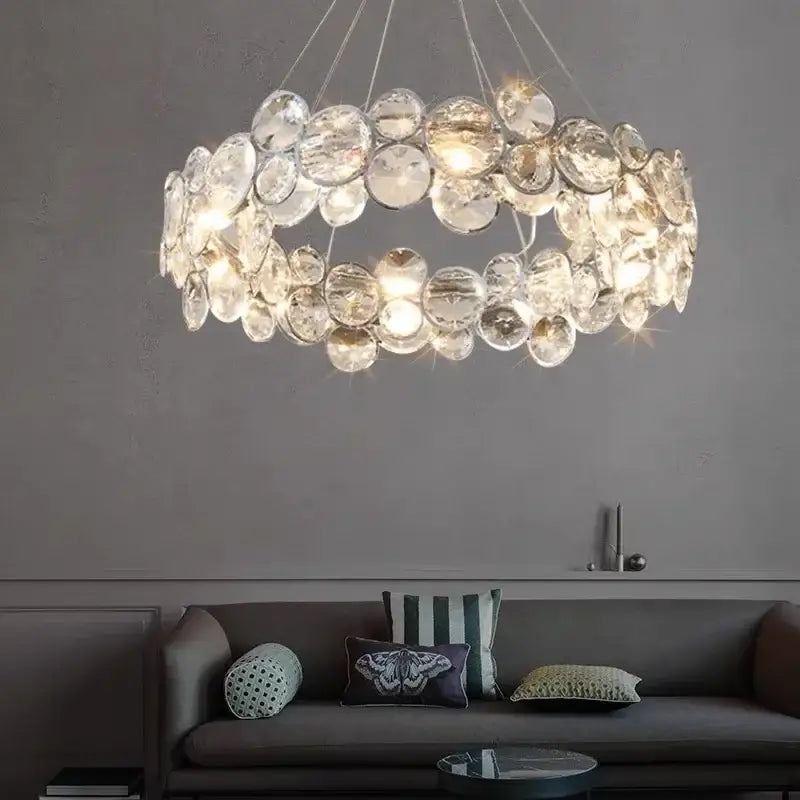 A modern chrome decorbites crystal led chandelier with clear faceted crystal discs for dining room lighting