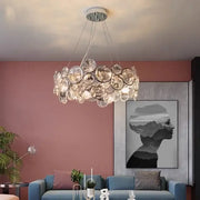A modern chrome decorbites crystal led chandelier with clear faceted glass discs for dining room lighting