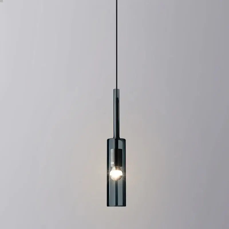 A sleek dark-tinted glass cylinder pendant light with black metal accents from decorbites glass chandeliers for living room lighting