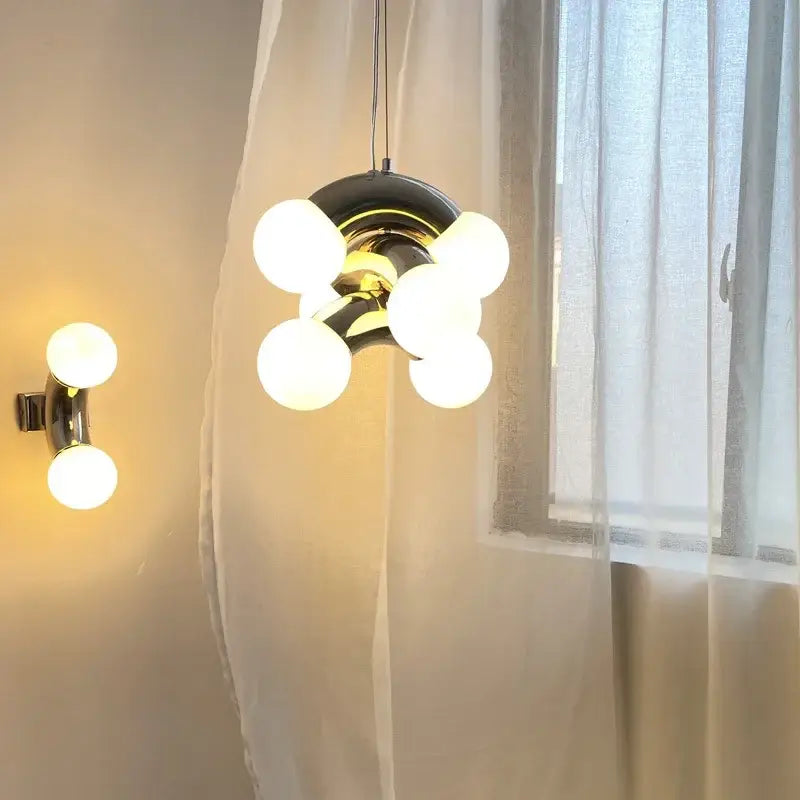 Modern black and brass decorbites designer grape wall sconce with six frosted glass globes for bedroom lighting